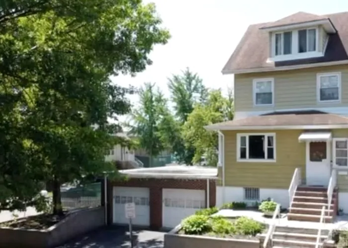 A freshly painted two-story house on a corner lot