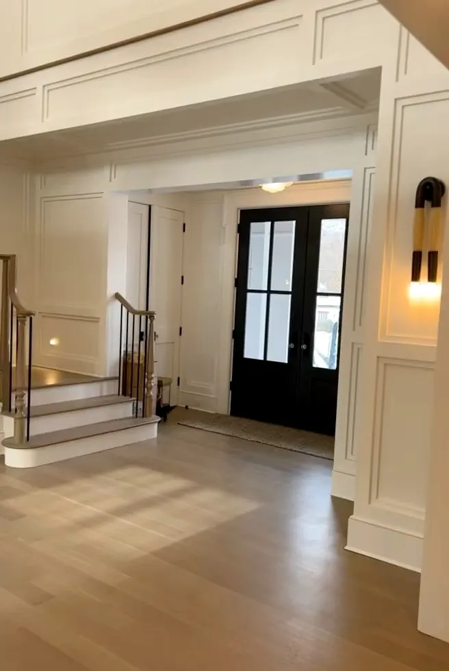 A bright entry with painted paneling and double doors