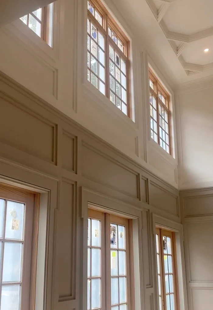 Two-story room: Paneling and window trim, painted crisp.